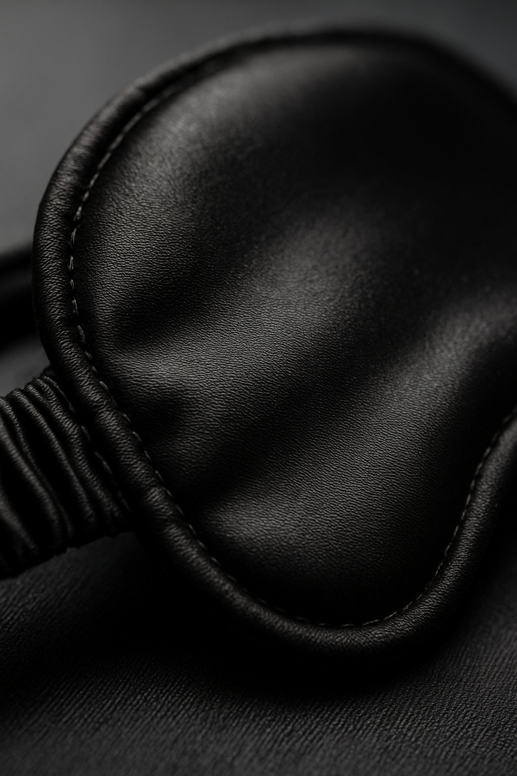 Close-up of black silk sleep mask stitching